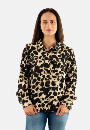 Camicia a maniche lunghe nera e beige con motivo a pois, dotata di chiusura con bottoni, due tasche sul petto e colletto.
