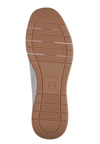 Sole di sneaker leggera con una superficie in gomma marrone testurizzata, caratterizzata da scanalature orizzontali e verticali per trazione e stabilità.