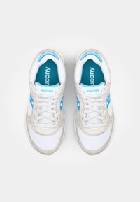 White sneakers with light gray accents, blue brand logo, and mesh detailing. Features a rounded toe and standard lacing. Internal blue lining.