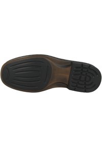 Schwarze Gummisohle mit strukturierten Griffmustern und einem braunen Akzent. Konturierte Form mit sichtbaren Profilrillen für verbesserte Traktion.