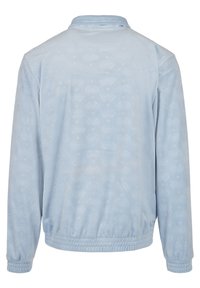 Veste bleu clair à manches longues avec un motif subtil sur toute la surface, poignets élastiques et taille élastiquée, vue de dos.