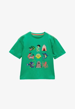 Grünes kurzärmliges Hemd mit bunten, bestickten Meeresbewohnern, darunter ein Krokodil, eine Qualle, ein Haifischmaul, eine Krabbe, ein Kugelfisch, ein Marlin, ein Anglerfisch, ein Walross und ein Oktopus.