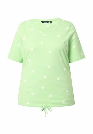 Lichtgroen T-shirt met korte mouwen, witte madeliefmotieven en een strikdetail aan de voorkant van de zoom.