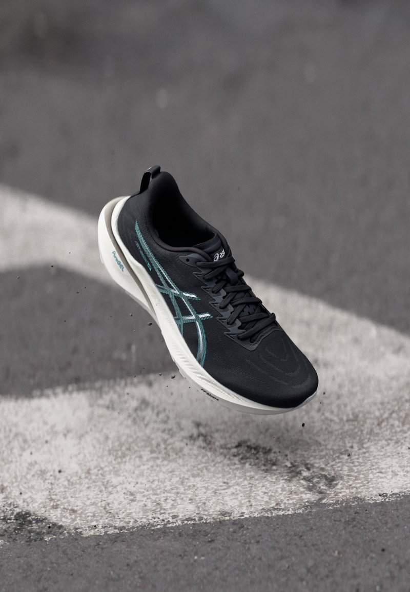Black athletic shoe with a mesh upper, teal accents, and a white cushioned sole, displaying a sleek aerodynamic design.