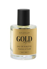 Bottiglia di vetro trasparente con un tappo nero, dotata di un'etichetta dorata con la scritta "GOLD Body Care." Contiene 50 ml di Eau de Toilette, "Essence of Gold."
