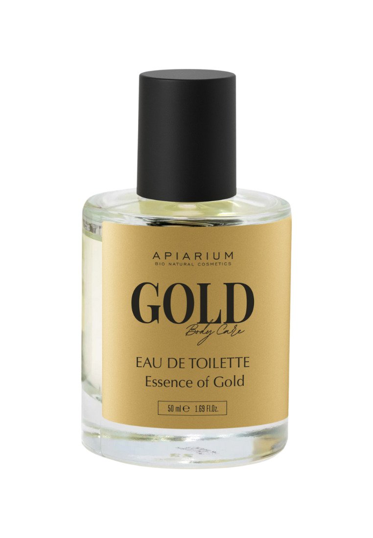 Bottiglia di vetro trasparente con un tappo nero, dotata di un'etichetta dorata con la scritta "GOLD Body Care." Contiene 50 ml di Eau de Toilette, "Essence of Gold."