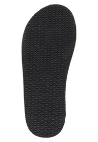 Schwarze Gummisohle mit einer gewellten Textur, ovaler Form und glatten Kanten, die für Fußunterstützung und Komfort entworfen wurde.