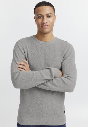 Gray ribbed knit sweater with long sleeves and a round neckline, featuring a fitted design and subtle texture.