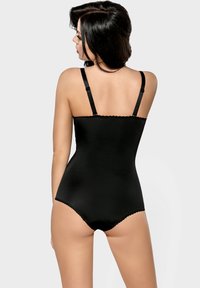 Schwarzer Bodysuit mit verstellbaren Trägern, glatter Textur, gewellten Kanten und fitted Design. Die Rückansicht betont den minimalistischen Stil.