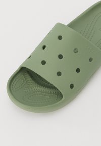 Infradito verdi realizzati in plastica morbida, con un design a fascia perforata, soletta testurizzata e punta aperta. Finitura liscia, leggero.