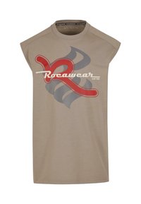 Beige sleeveless t-shirt featuring a large red and gray graphic logo design, with "Rocawear CLUB 1999" printed in white text.