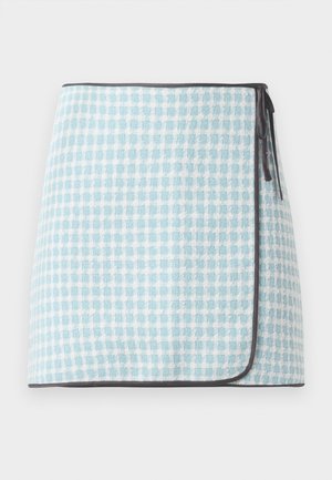 Wrap skirt in light blue and white checked pattern, featuring a soft texture and contrasting dark trim. Ties on the side for closure.