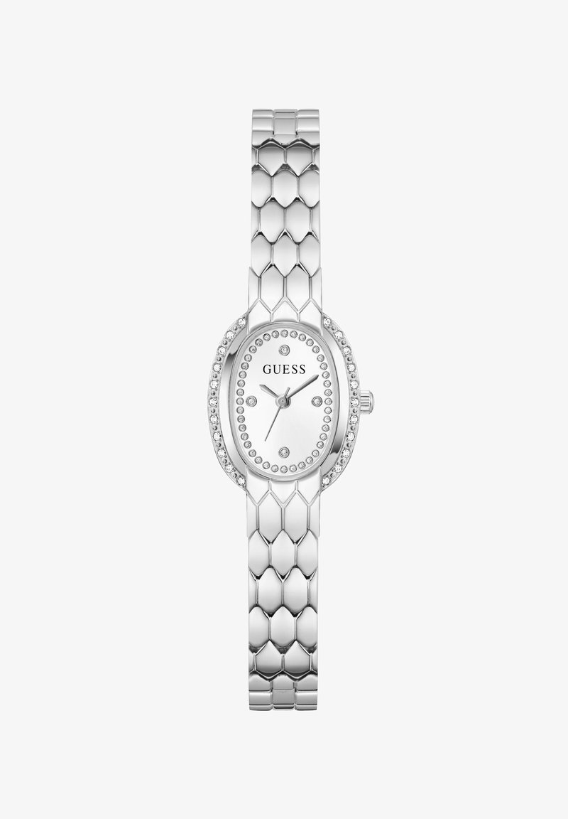 Ασημένιο οβάλ ρολόι Guess με κρυστάλλινες λεπτομέρειες στην στεφάνη και το καντράν, συνδεδεμένο μεταλλικό μπρασελέ και τριωνυκτική αναλογική ένδειξη.