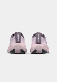 Pink and gray athletic shoes with a textured upper and hexagonal patterns, featuring "1080" branding on the heel and rubber sole accents.