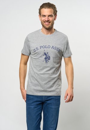 Siva majica kratkih rukava s okruglim izrezom, sa tamnoplavim printom "U.S. POLO ASSN" i grafikom igrača polo.