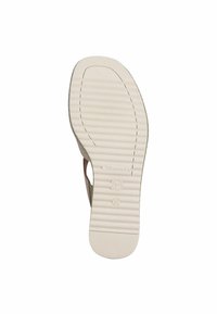 Ljusbeige gummisula med horisontella ränder, med en rundad form och präglad logotyp. Stl markerad som 37.