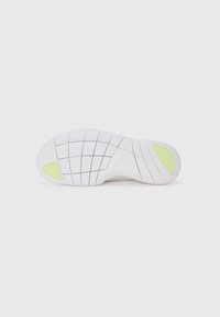 White sneaker sole with textured grip, featuring a grid pattern, yellow accents, and the Nike logo in a subtle design.