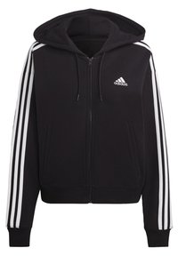 Svart Adidas huvtröja med dragkedja och vita tre ränder nerför ärmarna samt Adidas-logotyp på vänster bröst.