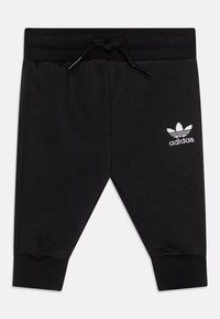 Pantaloni della tuta neri in misto cotone, con vita elastica e cordino, caratterizzati dal noto logo bianco di Adidas sul davanti.