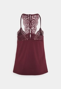 Canotta bordeaux con un design a pizzo sul retro, spalline regolabili e un tessuto liscio con una silhouette aderente.