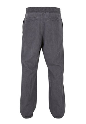 Pantaloni grigi, dal taglio morbido, con vita elasticizzata, due tasche posteriori e polsini svasati. Il tessuto sembra morbido e presenta una leggera texture.