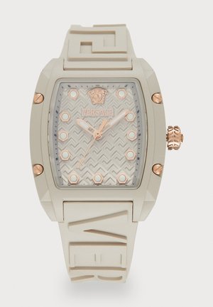 Versace watch featuring a rectangular, beige rubber case. Rose gold accents, patterned gray dial, and circular markers. Engraved logo, textured strap.