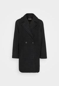 Cappotto nero doppiopetto con rever appuntiti, maniche lunghe e dettagli in cucitura bianca lungo le cuciture. Tessuto morbido con una forma strutturata.
