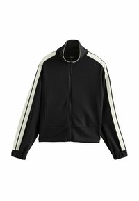 Chaqueta negra con cremallera y franjas laterales blancas, cuello alto y puños elásticos; fabricada con un material suave y elástico con un diseño corto.