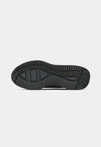 Black rubber shoe sole with deep treads and grooves. Features a smooth section and a "BOSS" logo embossed on the heel area.