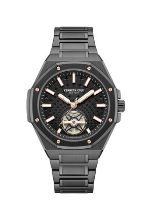 Kenneth Cole zwarte metalen horloge met gestructureerde wijzerplaat, uurmarkeringen en wijzers in roségoud, zichtbare automatische beweging en een schakelband.