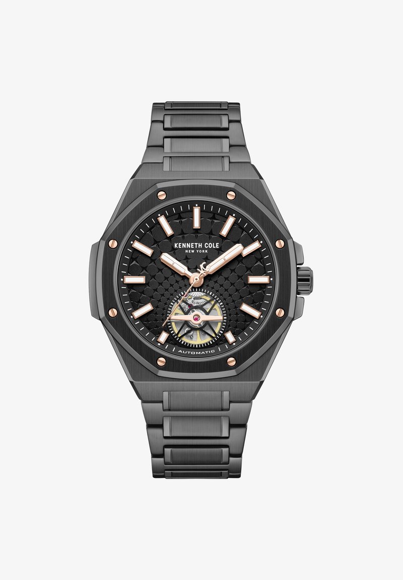 Montre en métal noir Kenneth Cole avec cadran texturé, index et aiguilles en or rose, mouvement automatique visible et bracelet à maillons.