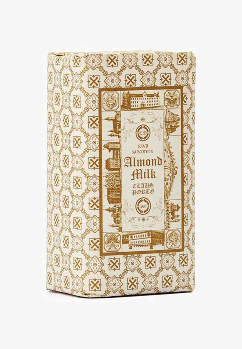 Mandelmilchseife in einer rechteckigen, braun-creamfarbenen Schachtel mit einem Muster, das Illustrationen historischer Gebäude und aufwendige Verzierungen zeigt.