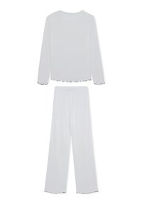 Ensemble composé d'un haut à manches longues blanc et d'un pantalon à jambes larges. Présente un tissu texturé avec des bords noir froncés aux manches et à l'ourlet. Léger et coupe ample.