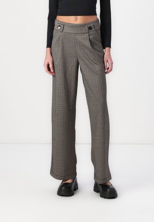 Pantalons taille haute à motifs à carreaux marron et beige, avec deux poches latérales et des boutons noirs contrastants. Le matériau est un tissu texturé.