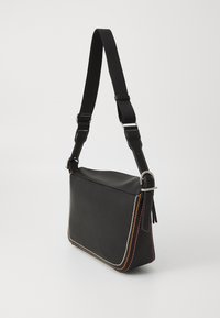 Czarna skórzana torba na ramię z kontrastowym przeszyciem w kolorze pomarańczowym, czerwonym i białym. Posiada regulowany czarny pasek oraz elegancki design.