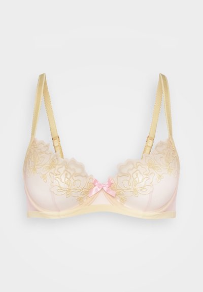 Beige bh med blomstermønster i gull, med en lys rosa sløyfe i midten, justerbare stropper og en semi-transparent tekstur.