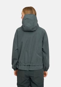 Dark green windbreaker jacket with a hood, elasticized hem and cuffs, and a relaxed fit. Made from a smooth, lightweight material.