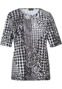 Schwarz-weißes T-Shirt mit einer Mischung aus Leoparden- und Hahnentrittmuster. Kurze Ärmel und ein runder Ausschnitt. Weicher, strukturierter Stoff.