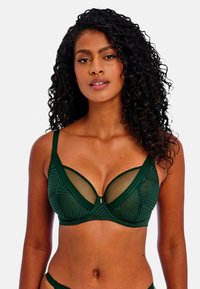 Soutien-gorge vert avec un motif géométrique, des panneaux en maille, un soutien-gorge à armatures, des bretelles réglables et un petit détail de fermoir à l'avant.