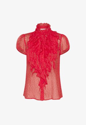 Červená priesvitná blúzka s riaseným predným dielom, vysokým výstrihom a krátkymi puffovými rukávmi. Biela bodkovaná vzorom po celom. Uzavretie na gombíky vpredu.