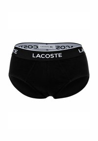 Caleçons en coton noir avec un design uni et une large ceinture affichant le logo blanc "LACOSTE" ainsi qu'une étiquette à l'arrière.