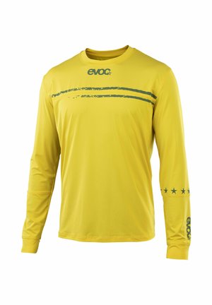 Yellow long-sleeve shirt with dark green "evoc" logo on chest and sleeve, two horizontal green stripes across upper chest, and five stars on right arm.