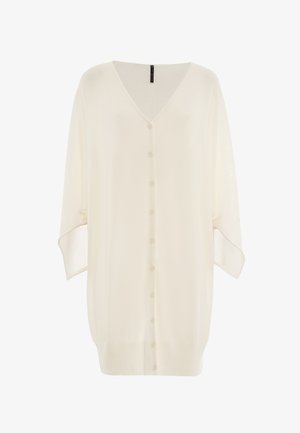 Un cardigan en crème doux et léger avec un col en V, une fermeture à boutons sur le devant, des épaules tombantes et un ourlet côtelé. Il présente de longues manches amples et un tricot texturé.