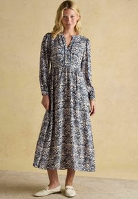 Tumesinine ja kreemikas lilleline pikkade varrukatega kleit, kerge kangas, A-line siluett, ümar kaelus ja nupud.