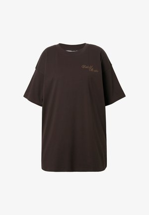 Bruine oversized t-shirt van katoen. Heeft een ronde hals en korte mouwen met "Untold Stories" geborduurd in een lichtere kleur.