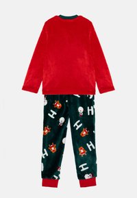 Red long-sleeve fleece top paired with dark green pants featuring white snowmen and reindeer patterns, elastic cuffs, and waistband.