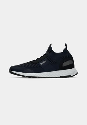 Navy athletic sneakers with a textured upper, featuring a white rubber sole and subtle branding. Includes a pull tab and patterned side accents.