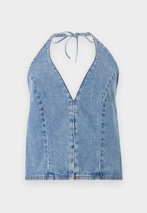 Denim halter top in light blue. Features a deep V-neckline, open back, and ties at the neck. Smooth texture with subtle stitching details.