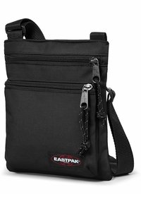 Borsa a tracolla nera realizzata in nylon resistente. Presenta due tasche anteriori con zip, una tracolla intrecciata e una patta con logo sul davanti.