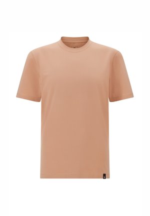 Light peach short-sleeve t-shirt made of soft fabric, featuring a round neck and minimalistic design, with a small logo tag at the bottom.